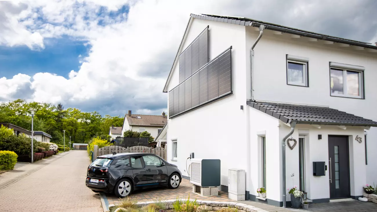 Haus mit Solarmodulen, Wärmepumpe und Wallbox für Elektroauto